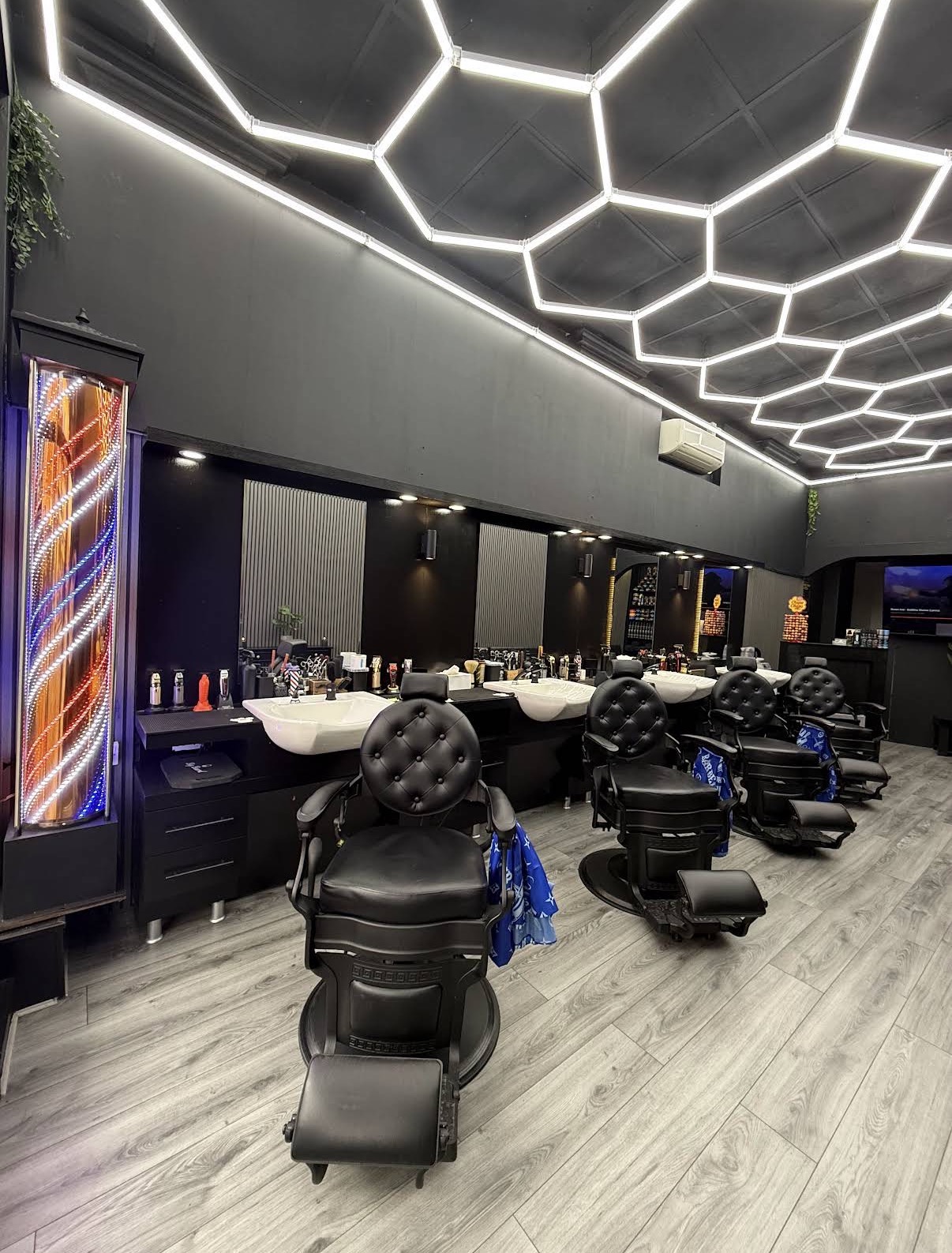 Interior of Brilliant Barber, Colchester — hexagon lighting and vintage chairs